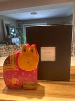 Front view of magenta cat bank and brown Milano photo album