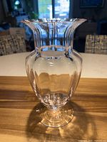Full view of light pink ribbed glass vase showing shape and color