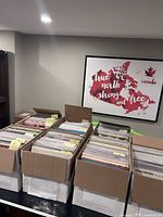 Seven open boxes filled with alphabetized LP records on tabletop