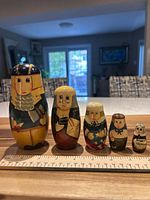 Front view of all five dolls with ruler showing scale