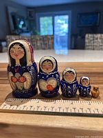 Front view of five nesting dolls lined up by size