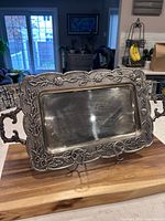 Front view of embossed metal tray on stand