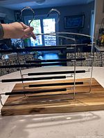 Both pant hangers standing on countertop showing chrome frame and black padded bars