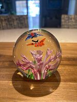 Front view of glass paperweight showing pink flower and two butterflies