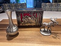 Bud vase, moose figurine and toffee tin grouped