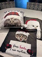 Three holiday pillow covers and insert displayed on table