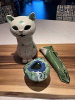 All three pottery pieces grouped on wood surface