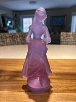 Front view of lilac frosted glass figurine holding fan