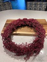 Front view of red bead wreath on cutting board