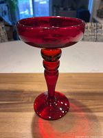 front view of red glass pillar candle holder