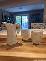 Group view of pitcher and two tumblers