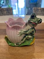 Front view showing frog, pink flower cup, lily pad base