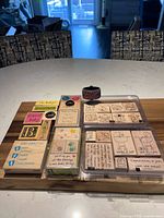 Full lot overview showing both Stampin’ Up! stamp sets in cases, loose stamps, and wheel