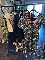 Front view of four garments on rack