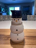 Front view of stacked snowman sugar and creamer showing overall design