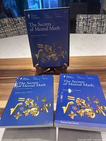 Front view showing DVD case on stand with guidebook and transcript book