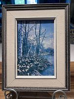 Full view of framed print on stand