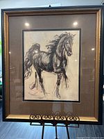 Full view of framed print on easel