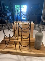 Overall view showing metal racks, wooden crate and stoneware bottle