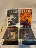 Front view of four bagged B.P.R.D. comic issues