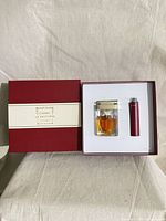 Presentation box opened showing perfume bottle and travel atomizer