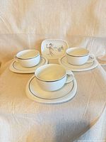Set showing 3 cups, 3 saucers, 3 plates and decorated tray