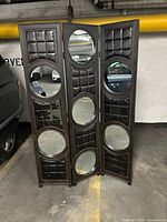 Front view of three-panel divider showing mirrors and padded sections