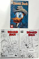 Front view of all three bagged and boarded Donald Duck variant comics