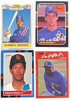 Group shot of all four rookie baseball cards in sleeves