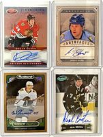 Front view of all four autographed hockey cards in top loaders