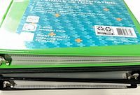 Stacked view of green and black binders showing vinyl covers and O-ring spine labels