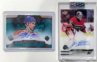 Both autographed rookie cards in top loaders side by side