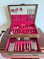 Open two-tier chest showing all flatware pieces arranged