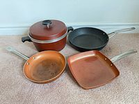 All four pans and lid displayed upright
