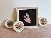 Front view of all four framed needlepoints