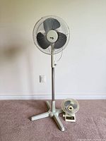 Pedestal and desk fans together for size comparison