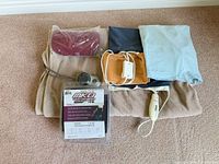 Group shot of blanket, heating pad, covers, back brace package and controllers
