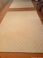 Full view of beige checker rug