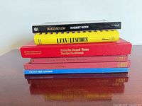 Stack of six cookbooks side view