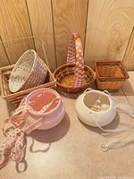 Group shot of four wicker baskets and two ceramic hanging planters