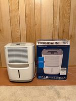 Front view of dehumidifier alongside original box