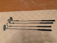 Full length view of all four golf clubs
