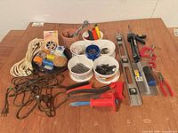 Full lot overview showing all hand tools, hardware containers, rope and cords