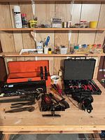 Overall view of benches with toolboxes, clamp sets, hard case and loose tools