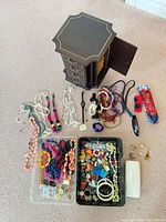 overall lot showing jewelry box, trays of jewelry, watch and Versace case