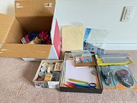 Entire lot showing boxes with ribbons, paper, stamps, packaged punches and trimmer