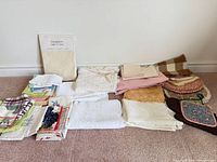 Full lot of assorted linens and potholders laid out