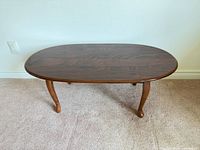 top view showing oval shape, wood grain, glossy finish