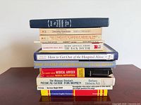 Full stack of twelve books showing spines and formats