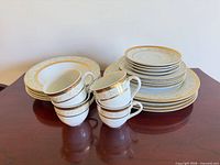 Stacks of mixed plates, bowls and five cups showing pattern and condition